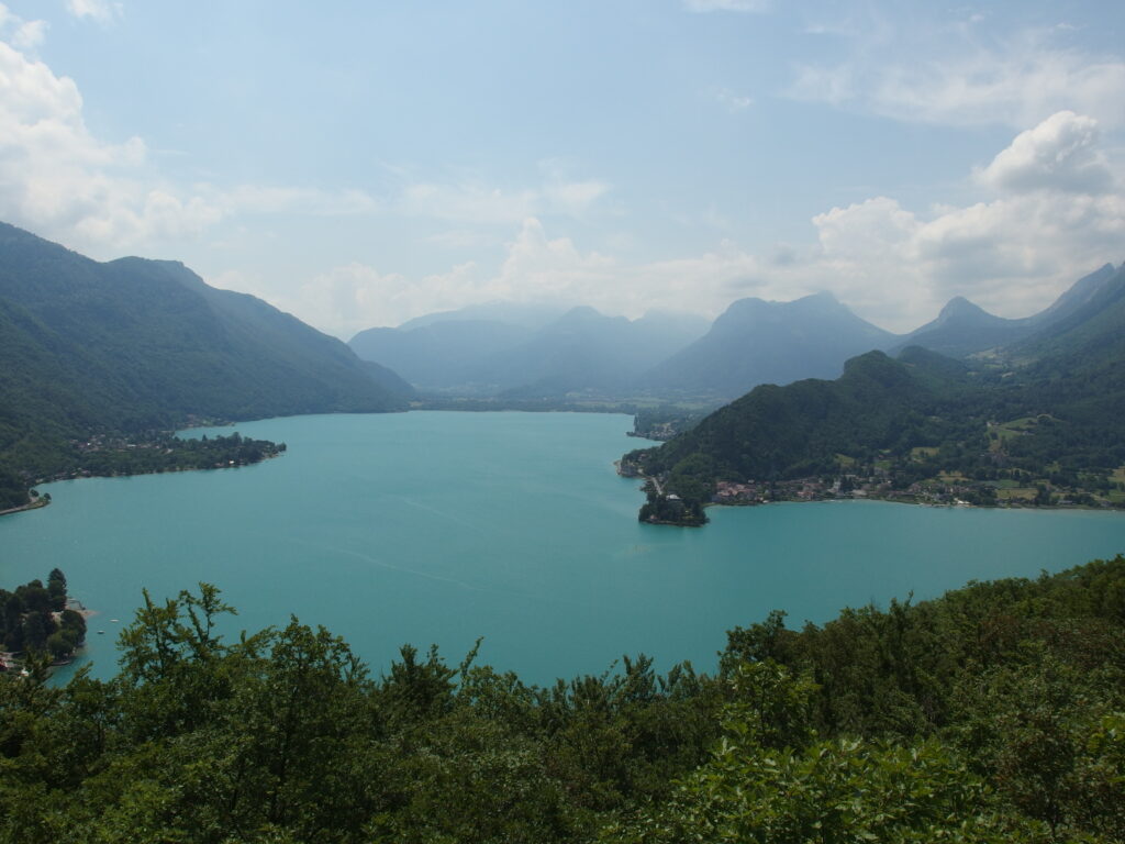 Le lac d'Annecy vu en plongée au-dessus de la canopée, depuis le Roc de Chère à Talloires.